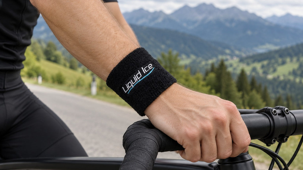 A cyclist on a mountain road, a black Liquid Ice wristband on his wrist