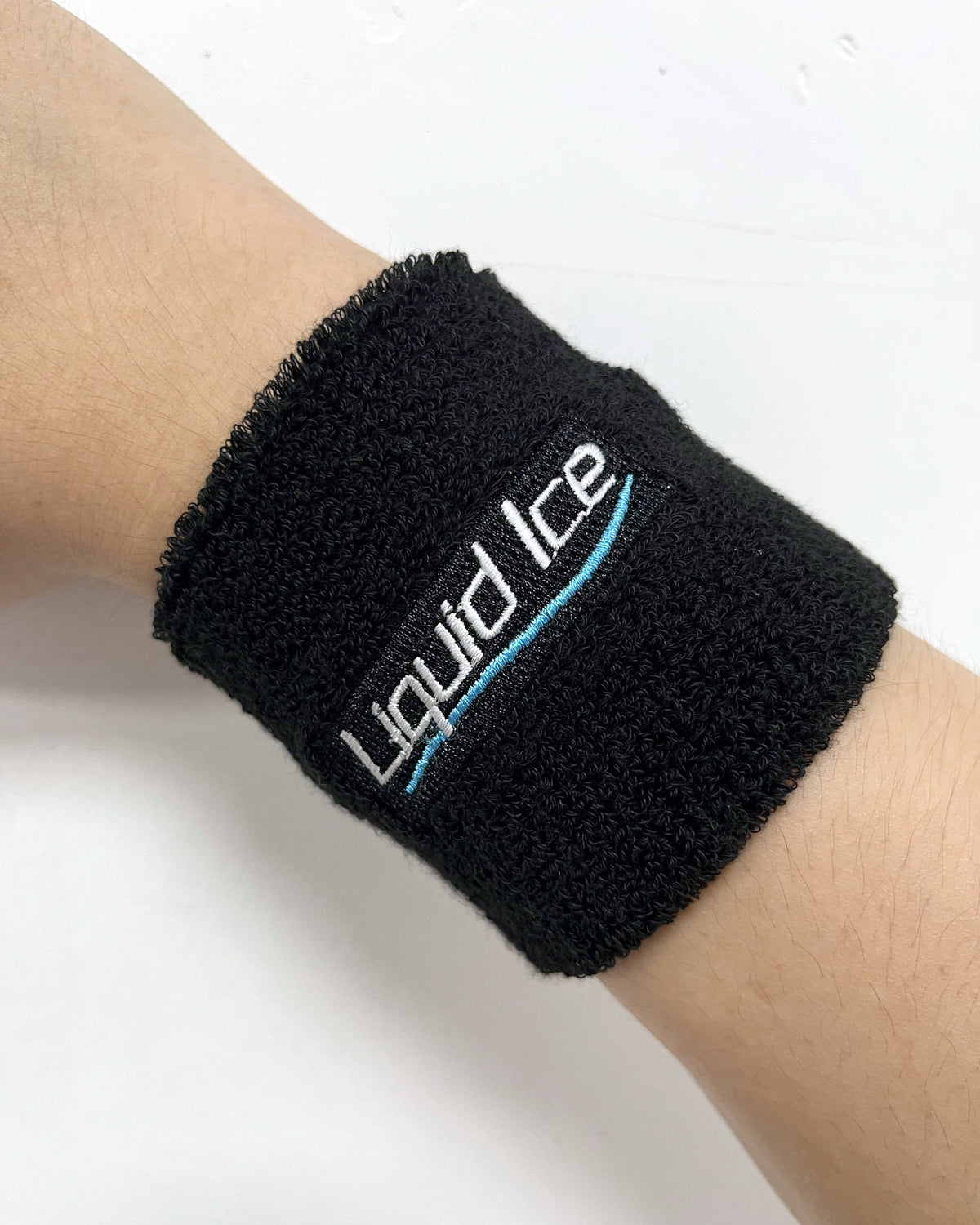 A Liquid Ice terry wristband on a wrist